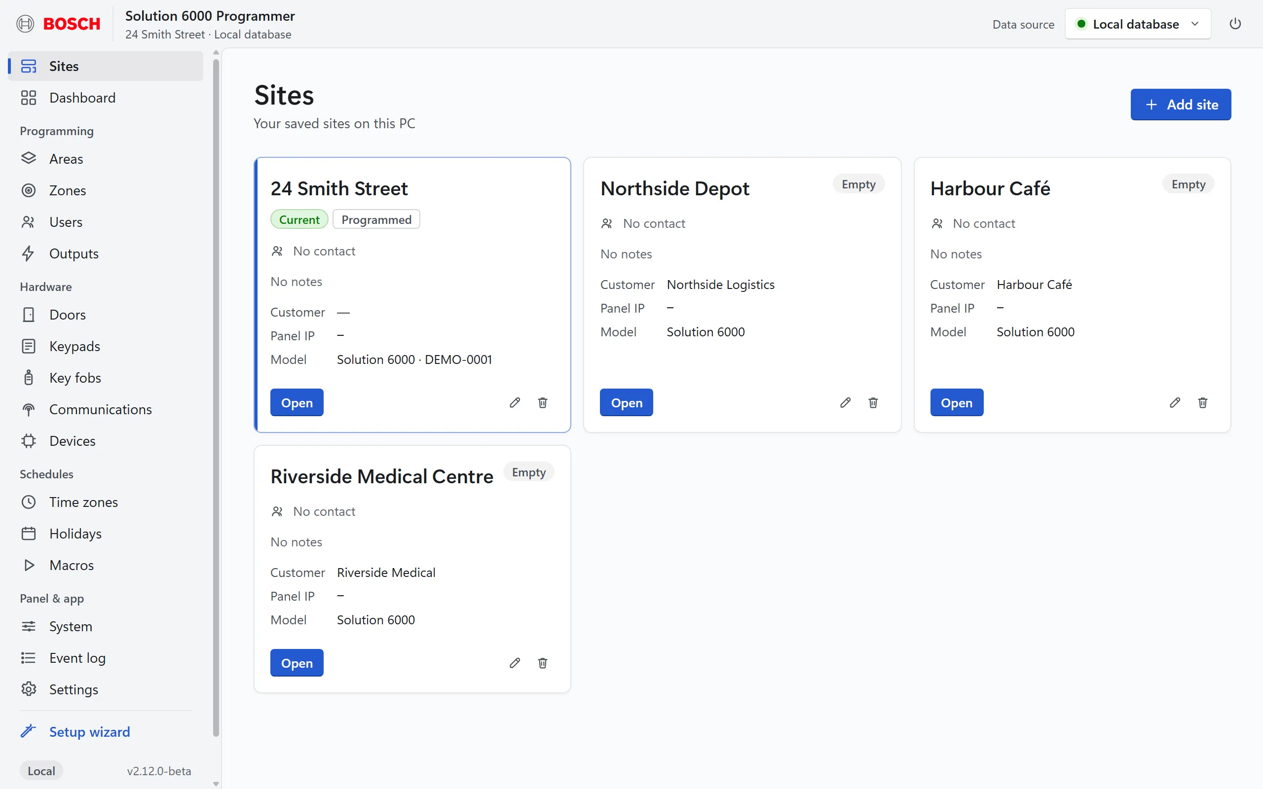 The site library showing four demo customer sites as cards, each with an Open button.